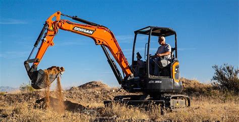 mini excavator on grass|How to use a compact excavator to complete landscaping jobs.